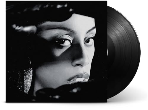Black and white vinyl record cover with woman's face partially obscured by shadows.