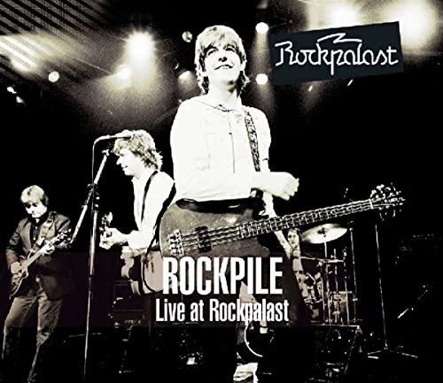 Black and white concert photo of the band Rockpile performing on stage at Rockpalast.
