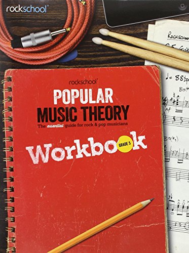 Red Rockschool Grade 5 music theory workbook with pencil and musical items.