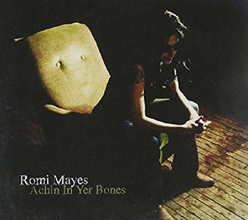 CD cover for Romi Mayes’ “Achin In Yer Bones” featuring a woman and chair.