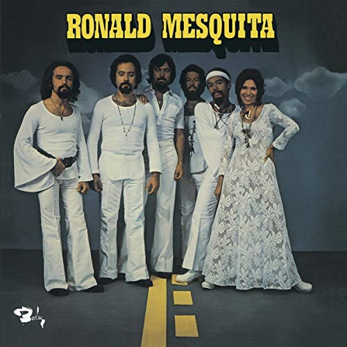 Vinyl album cover featuring a group portrait of six people in white clothing.