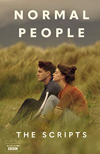 A young man and woman sit in tall grass, with book title text above them.