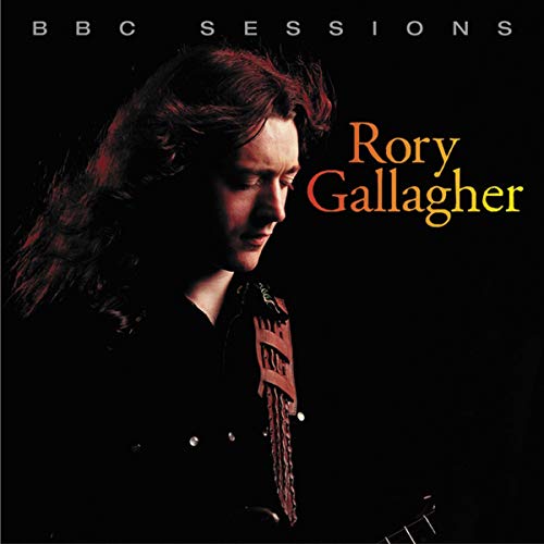 Rory Gallagher portrait on CD cover, dark background, long hair, guitar.