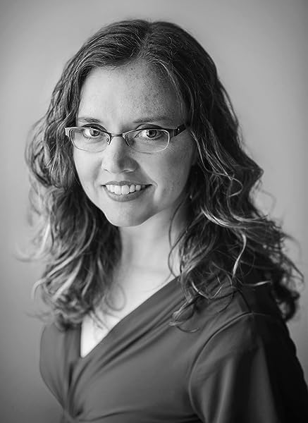 Black and white portrait of a woman with wavy hair and glasses.