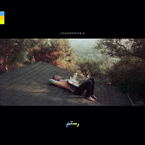 CD cover: man lying on a roof, playing guitar, misty landscape.