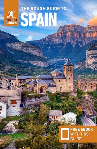 The Rough Guide to Spain travel book cover featuring a stone village and mountains.