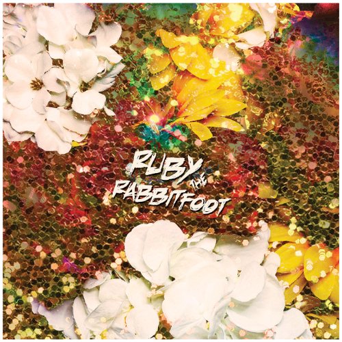 Album cover featuring white flowers and yellow petals over a background of gold sequins.