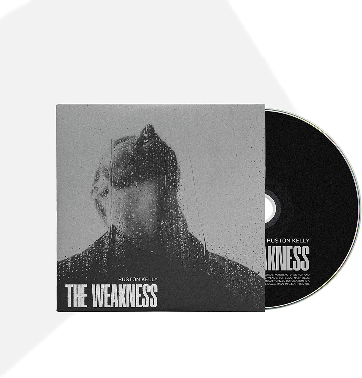 "CD case with a black and white cover and a black disc."
