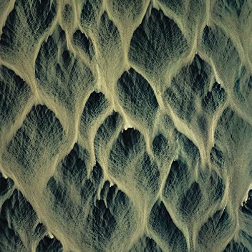 Aerial view of textured sand patterns resembling ocean waves.