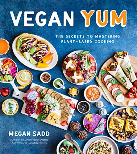 Cookbook cover featuring colorful vegan food arranged on a light surface.