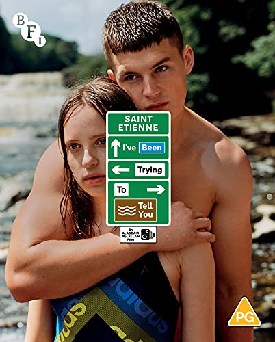 Couple embracing, with a green road sign reading "Saint Etienne: I've Been Trying To Tell You".