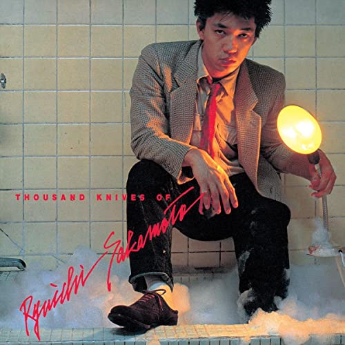 Ryuichi Sakamoto album cover: man in suit, illuminated by a lamp.