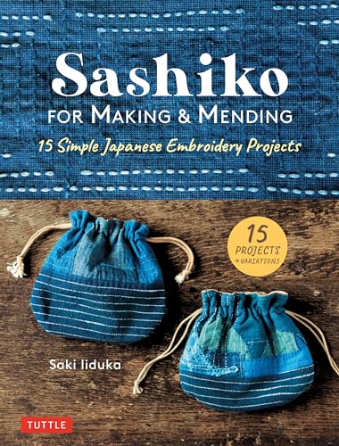 Book cover showing two small blue drawstring bags with white sashiko embroidery on wood.