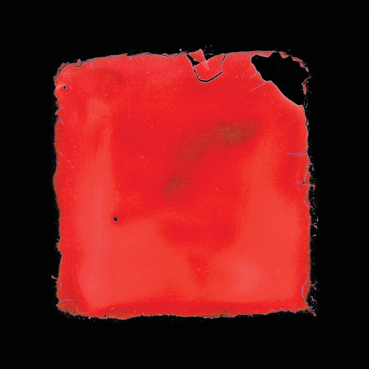 Red square with distressed edges on a black background.