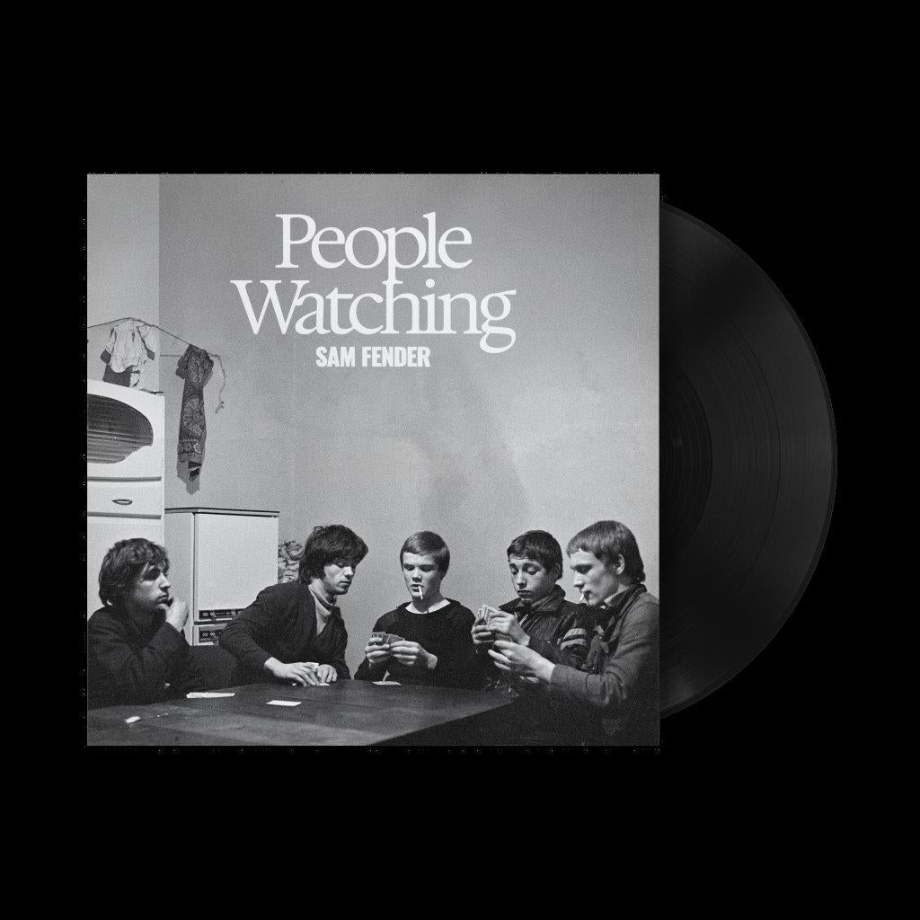 A vinyl record of Sam Fender's album 'People Watching' with a black and white cover featuring the artist and a group of people sitting around a table.