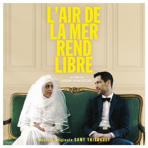 CD cover: couple in wedding attire seated on a green sofa.