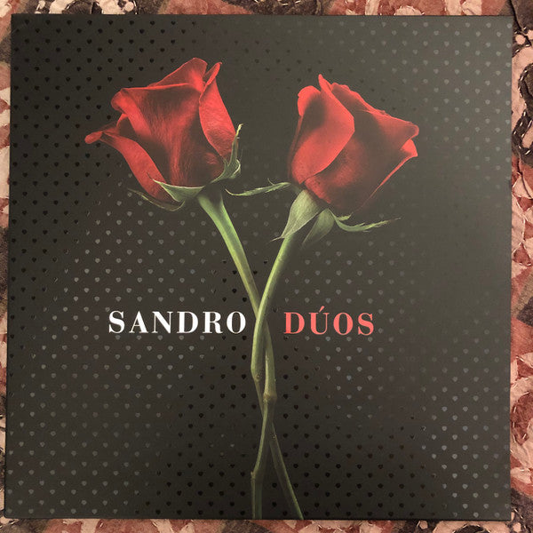 Vinyl record cover with two red roses against a dark, speckled background.