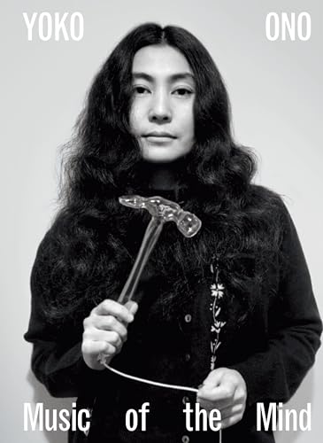 Black and white portrait of Yoko Ono holding a hammer and string.
