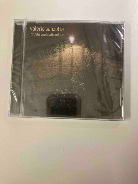 CD case with a dark, blurry landscape featuring a streetlamp.
