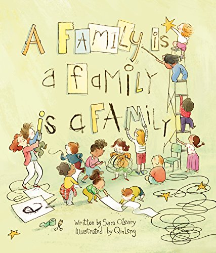 Children and adults arrange colorful block letters spelling "A Family Is a Family.