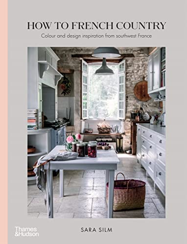 Book cover showing a rustic French kitchen with stone walls, white cabinets, and island.
