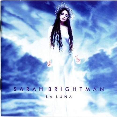 Sarah Brightman in a white gown, surrounded by blue clouds.