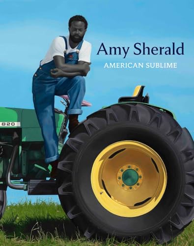 A man in overalls leans against a green tractor under a bright blue sky.