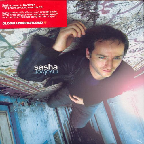 Man in black shirt lies on graffiti-covered stairs, looking up, with "sasha" text on sleeve.