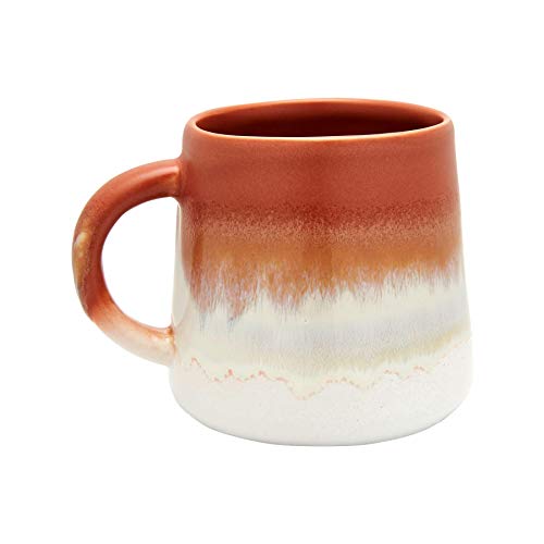 Terracotta mug with a reactive glaze, transitioning from white to orange.