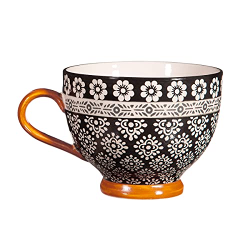 Black and white patterned teacup with orange handle and base.