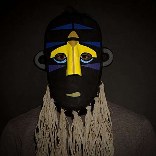 Person wearing a black mask with yellow and blue geometric shapes.