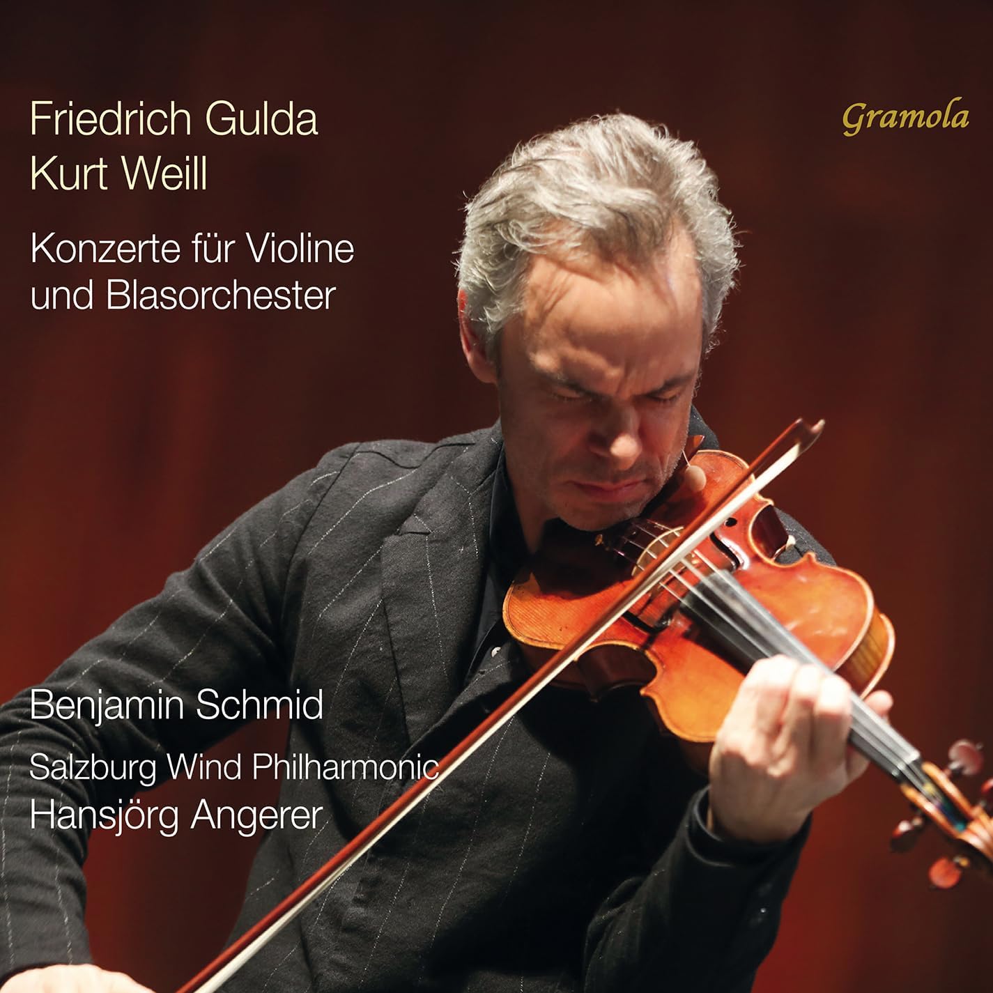 CD cover featuring a violinist with a dark background and text.