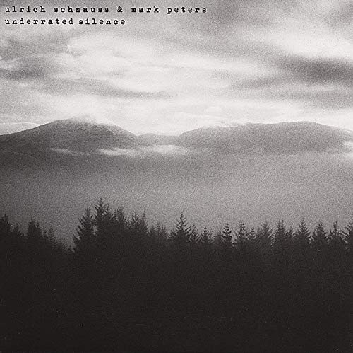 Black and white album cover with mountains and silhouetted trees.