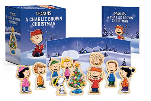 Wooden Peanuts characters and a Christmas tree inside a gift box.