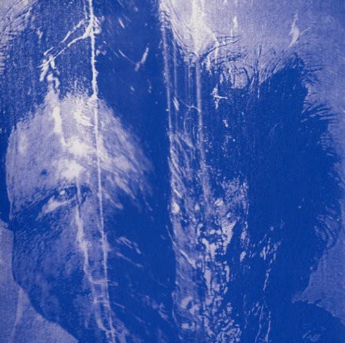 Blurred, blue-toned portrait of a person, likely a record album cover.