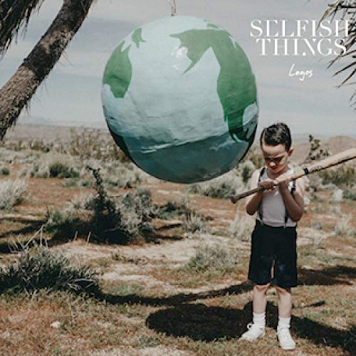 "Album cover with a boy holding a globe on a stick in a desert landscape."