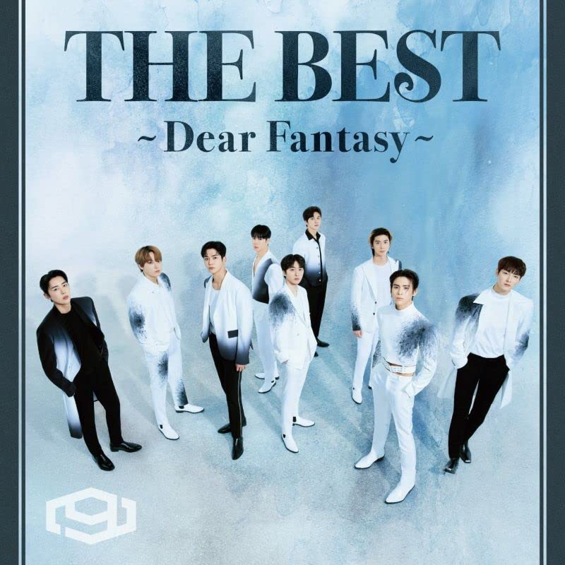 Sf9 band members in white suits against a smoky blue background.