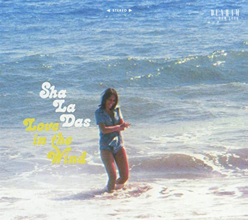 CD cover: woman on beach with album title “Love In The Wind”.