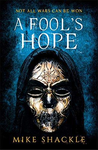 Book cover: masked figure with golden face, dark background, title text.
