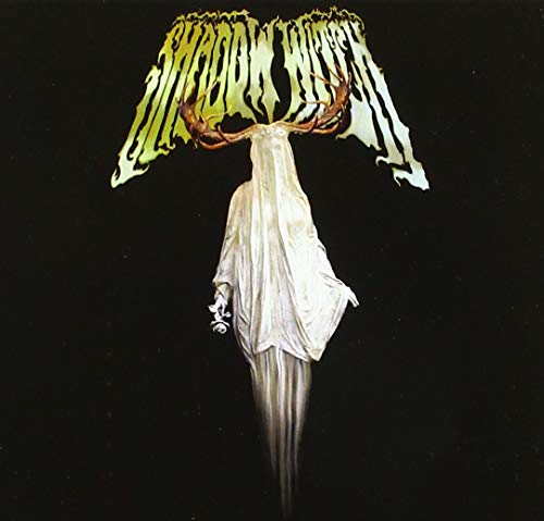 Figure with antlers and wings, draped in white, against black background.