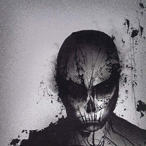 Black and white abstract image of a skull-like face with splatters.