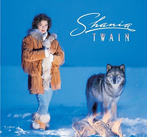 Shania Twain album cover featuring the artist with a wolf and fire.
