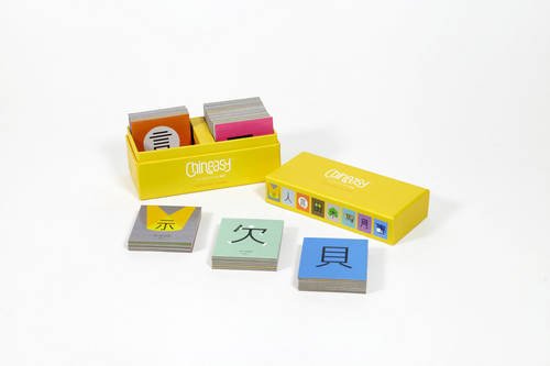 Yellow box with stacks of square cards featuring Chinese characters.