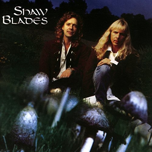Album cover of "Shaw Blades - Hallucination" featuring two people sitting among mushrooms.