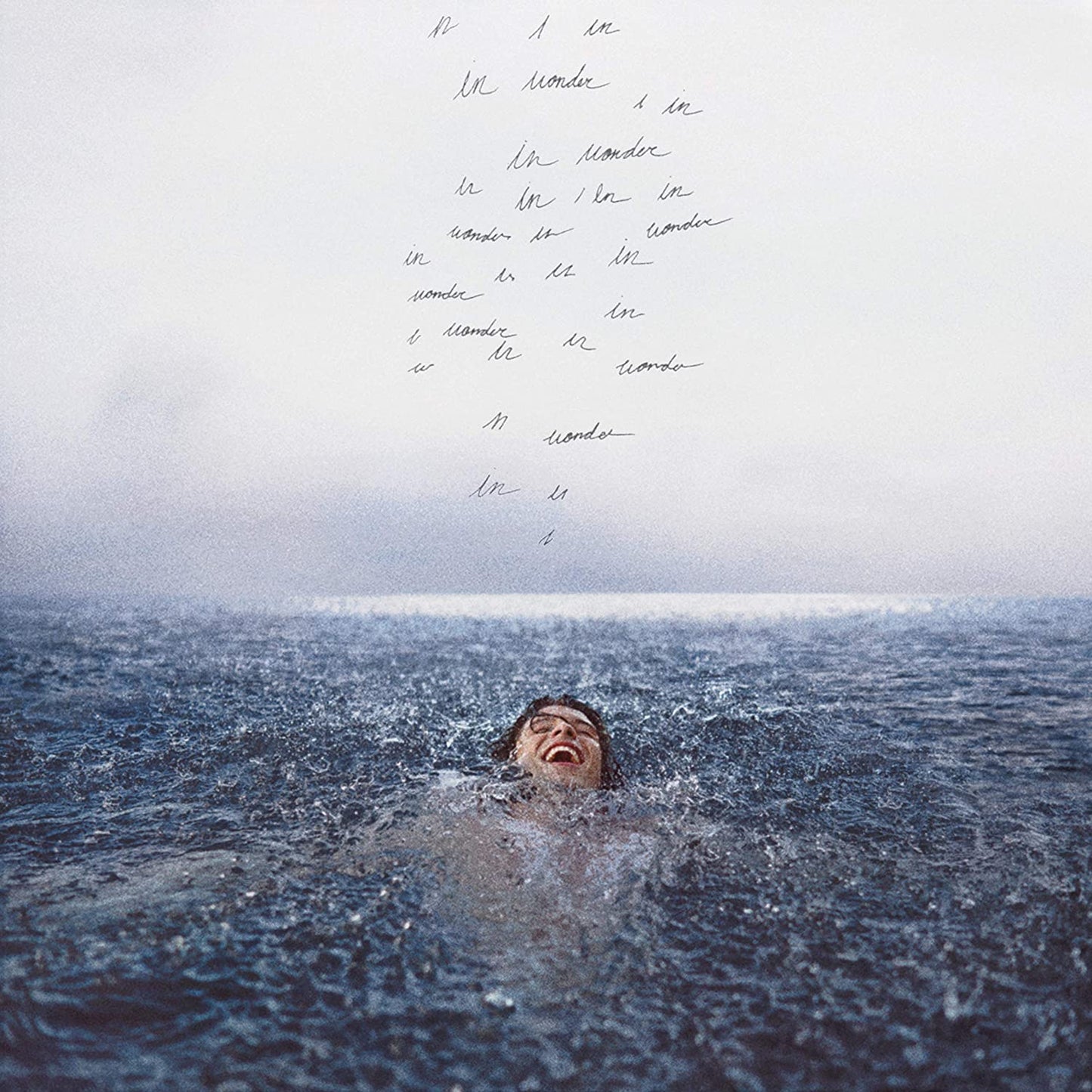 "Album cover with a man submerged in water, text dripping from the top."