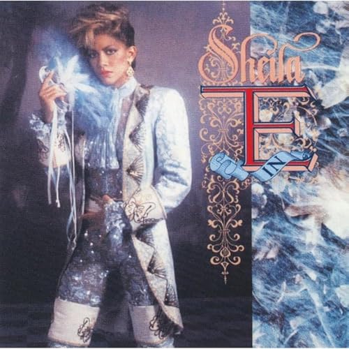 Sheila E. wearing a blue ornate historical-style costume on the Romance 1600 album cover.