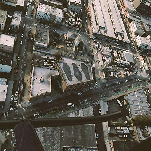 Aerial view of a dense urban cityscape with buildings and streets.