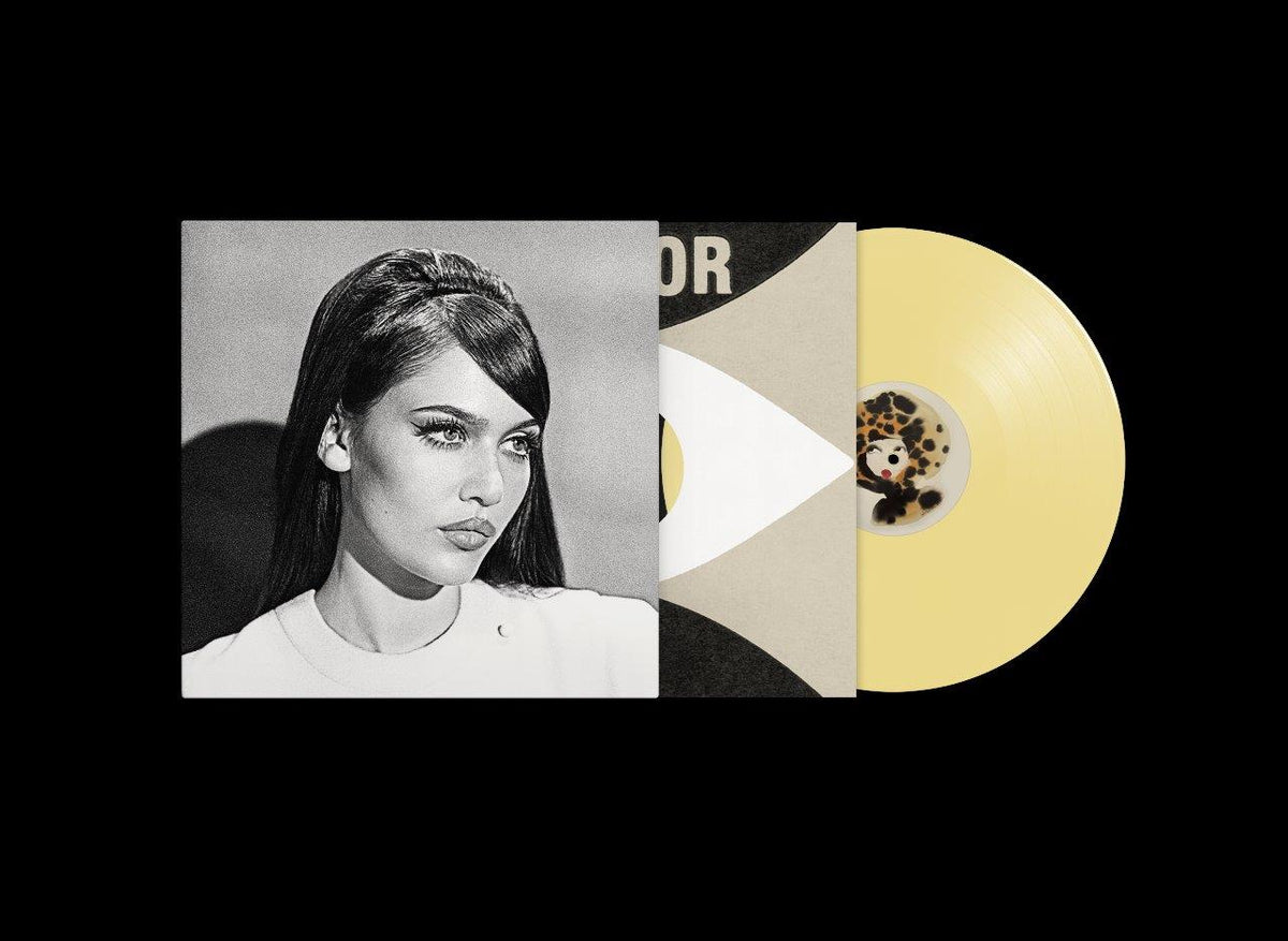 Vinyl record with album cover featuring a woman’s portrait and beige packaging.