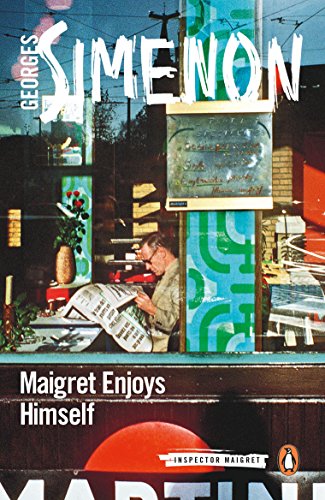 A man reads a newspaper inside a cafe viewed through a glass window.