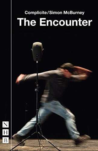Blurred figure performing near a vintage microphone on stage.